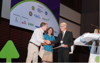 Drs Luís F. Gusmão of the Universidade Estadual de Feira de Santana in Bahia, Brazil and Elizabeth Arnold of the University of Arizona receive their International Mycological Association Young Mycologist Awards from IMA President John Taylor of the University of California, Berkeley at IMC10 in Bangkok, Thailand.  Photo credit: IMC10